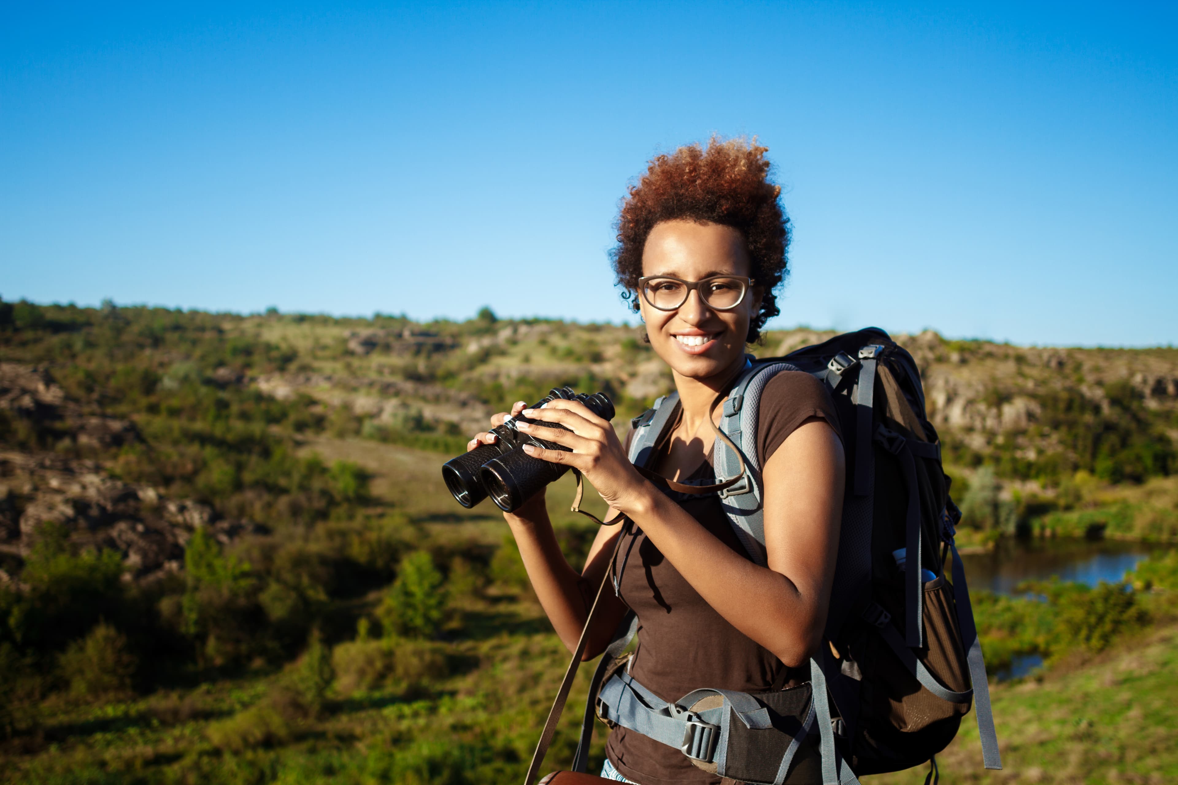 Traveler carrying a backpack and binoculars